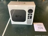 Front view of the sealed Apple TV 4K box with image of device and Siri remote