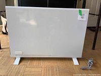 Front view of the heater showing slim panel, feet and power cord