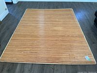 Full view of bamboo carpet laid flat on floor showing natural bamboo tones and size