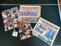 Photo showing the collection of 1992 Toronto Blue Jays memorabilia including Sports Illustrated magazine and Sunday Star newspapers.