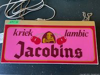 Front view of double-sided pink light-up sign with Jacobins cherry beer branding featuring cherries and a man holding a beer.