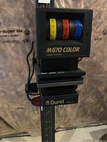 Photo of Durst M670 Color head showing three color filter wheels in yellow, red, and blue and labeled M670 COLOR.