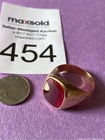 Ring front view next to coin and lot tag