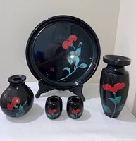 Front view of entire set showing all five lacquer ware items with hibiscus design.
