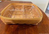 Square woven Longaberger basket with clear plastic insert fitting inside and divided into compartments, displayed from angled top view.