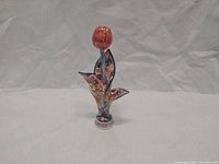 Front view of porcelain tulip bud vase showing overall shape and hand-painted design