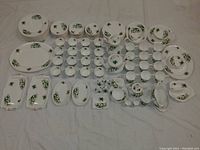 Full overview of entire dinnerware spread laid out to show quantity and variety