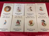 Photo shows 8 hardcover Beatrix Potter books with illustrated covers featuring various characters.