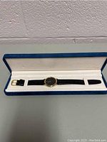 Birks watch displayed inside blue velvet-like box with white inner lining.