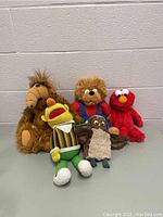Full lot of five stuffed toys showing ALF, Bert, teddy bear, Elmo, and owl