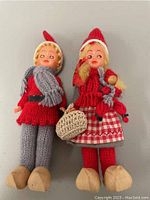 Two vintage handmade dolls together, showing full body and wooden clogs