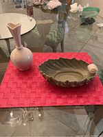 Photo showing both the Lenox decorative leaf bowl and the bulb vase on a red placemat on a glass table.