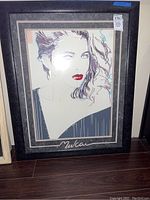 Framed lithograph shown fully, highlighting artist signature and overall frame condition.