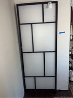 Full view of one panel of the tri-fold screen showing geometric frosted panels within a black frame.