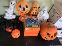 Wide view of all Halloween blow molds, plastic pumpkins, and boxed Shadow Maker projector showing lot contents and scale.