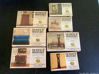 Photo shows seven boxed miniature dollhouse furniture sets from The House of Miniatures and one unboxed blue sofa, some sealed and some unsealed.