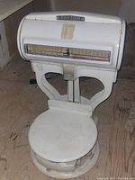 Front angle showing large round platform, glass front weight measurement scale with pounds, and 'Dayton' branding on scale hood.