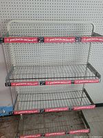 Front view of three-tier chip bag wire retail rack with red advertising trim, measuring about 36x50 inches.