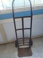 Front view of the heavy duty metal dolly showing the frame and wheels.