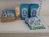 Lot of pet care products featuring Yep Paw Wipes, Arm & Hammer Odor Remover, and other pet wipes in packaging with dog images.