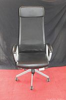 Front view of black Markus office chair showing high back, padded armrests, and seat.
