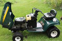 Side view of the green Craftsman tractor with open hood showing the John Deere engine.