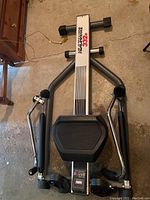 Top view of the Healthware rowing machine showing the padded handles, main frame, and foot pedals.