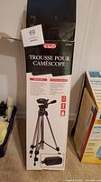 Image of unopened Optex tripod box with product details and brand visible.