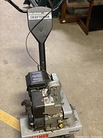Front view of Craftsman 5HP front tine tiller showing engine and tines.