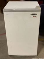 Front view of the white Haier mini refrigerator showing the door and handle