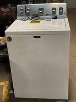 Front and side view of white Maytag top load washer showing cabinet and control panel