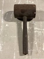 Top view of the vintage wooden gavel showing cylindrical head and handle.