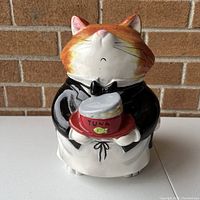 Front view of the complete cat butler cookie jar with detailed facial features and clothing as one piece.