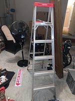 Wide shot showing both ladders in garage