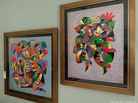 Front view of both framed abstract jester prints side by side