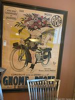 Full view of framed poster leaning against wall