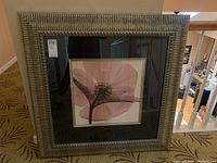 Front view of the pink flower art print in distressed metallic frame with black mat and cream inner border.