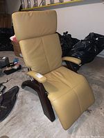 Front view of the chair upright showing backrest, seat pad, armrests and wood frame