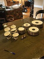 Overhead view of all plates, cups, saucers and shakers laid out on table.