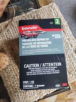 Front view of Bondo Fiberglass Repair Kit box showing brand, purpose, and caution information.
