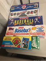 Five unopened vintage baseball card sets from 1989-1991 in original boxes including Score, Fleer, Topps, and Bowman.
