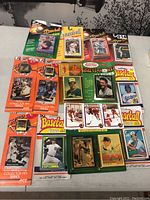 Overall view of the lot showing various unopened baseball card packs and NHL pins.