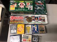 View of three boxed baseball card sets from early 1990s with clear identifying text and images of players on packaging.