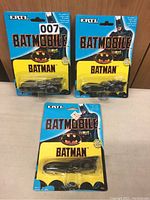 Photo showing all three Ertl Batmobile cars in original packaging standing side by side