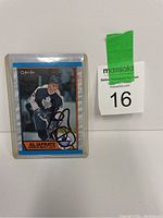 Photo of Al Iafrate hockey card signed on the front, showing card details and protective casing.