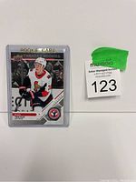 Photo of Brady Tkachuk rookie card in protective sleeve with lot number label.