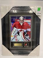 Shrink-wrapped black frame containing 8x10 Carey Price photo, double mat, metal plaque and logo