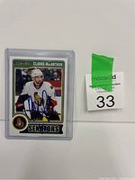 Photo of Clarke MacArthur Ottawa Senators hockey trading card with autograph in protective sleeve.