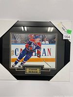 Framed 8x10 photograph showing Connor McDavid skating on ice, with Edmonton Oilers jersey and name plaque beneath photo.