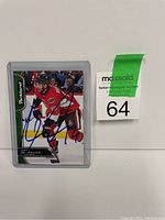 Front view of Derick Brassard hockey card signed in blue ink, with Parkhurst branding, inside protective plastic.